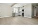A modern kitchen features white cabinets, stainless steel appliances, and light wood flooring at 9329 Russell Cir, Arvada, CO 80007