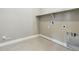 Efficient laundry room setup with tile floors and utility connections at 9329 Russell Cir, Arvada, CO 80007
