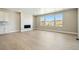 Comfortable living room with modern fireplace, recessed lighting, and large windows with views at 9329 Russell Cir, Arvada, CO 80007