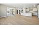 Spacious open-concept living area with wood floors, recessed lighting, and sliding glass doors to the patio at 9329 Russell Cir, Arvada, CO 80007