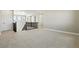 Spacious upstairs living room with carpeting, black railing, and lots of natural light at 9329 Russell Cir, Arvada, CO 80007