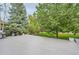 Spacious backyard features a tiled patio and lush green trees at 6598 S Telluride St, Aurora, CO 80016