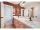 Bathroom features a double sink vanity, neutral tile, and a large mirror at 6598 S Telluride St, Aurora, CO 80016