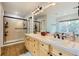 Bright bathroom features a double sink vanity with a walk-in shower at 6598 S Telluride St, Aurora, CO 80016