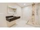Modern bathroom features a stone shower and floating vanity sink at 6598 S Telluride St, Aurora, CO 80016