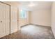 Carpeted bedroom features a closet and a window for natural light at 6598 S Telluride St, Aurora, CO 80016
