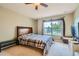 Carpeted bedroom features a ceiling fan and a window with a view at 6598 S Telluride St, Aurora, CO 80016