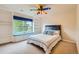 Bright bedroom with a unique ceiling fan and large window seat at 6598 S Telluride St, Aurora, CO 80016