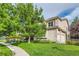 Charming home exterior featuring lush greenery and a well-maintained lawn at 6598 S Telluride St, Aurora, CO 80016