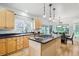 Modern kitchen with a center island, gas stove, and stainless steel appliances at 6598 S Telluride St, Aurora, CO 80016