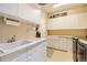 Functional laundry room with ample cabinetry, a utility sink, counter space, and modern washing machine at 6598 S Telluride St, Aurora, CO 80016