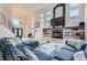 Open-concept living area featuring modern decor, a fireplace, and plenty of natural light at 6598 S Telluride St, Aurora, CO 80016