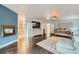 Open main bedroom with hardwood floors, fireplace, and an adjacent bathroom at 6598 S Telluride St, Aurora, CO 80016
