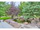 Backyard pond with rock features, landscaping, and waterfall offers a peaceful retreat at 6598 S Telluride St, Aurora, CO 80016