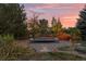 Landscaped backyard with trampoline at sunset at 5320 S Race Ct, Greenwood Village, CO 80121