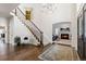 Grand entry with hardwood floors, a curved staircase, and fireplace at 5320 S Race Ct, Greenwood Village, CO 80121