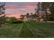 Two-story home with landscaped yard at sunset at 5320 S Race Ct, Greenwood Village, CO 80121
