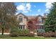 Brick two-story house with landscaped yard and circular driveway at 5320 S Race Ct, Greenwood Village, CO 80121