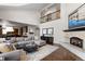 Spacious living room featuring a cozy fireplace and large sectional sofa at 5320 S Race Ct, Greenwood Village, CO 80121