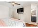 Bright bedroom with ceiling fan and view to bathroom at 5512 S Greenwood St, Littleton, CO 80120