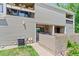 Exterior view of condo showing private patio, green space, and building architecture at 5512 S Greenwood St, Littleton, CO 80120