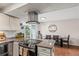 Modern kitchen with granite counters, stainless steel, island, and breakfast nook at 5512 S Greenwood St, Littleton, CO 80120
