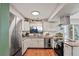 Charming kitchen featuring granite counters, stainless steel appliances, and wood flooring at 5512 S Greenwood St, Littleton, CO 80120
