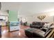 Living room flows into dining area, featuring hardwood floors, an aquarium, and a leather sectional sofa at 5512 S Greenwood St, Littleton, CO 80120