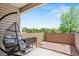Private outdoor patio area with hanging chair, brick surround and space for gardening at 5512 S Greenwood St, Littleton, CO 80120