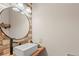 Bathroom featuring modern sink and wood accent wall at 5512 S Greenwood St, Littleton, CO 80120