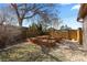 Backyard showcasing a fenced yard with raised garden beds at 3225 S Sherman St, Englewood, CO 80113