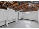 Unfinished basement with painted floors and walls, and exposed ceiling at 3225 S Sherman St, Englewood, CO 80113