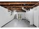 Unfinished basement with painted floors and walls, and exposed ceiling at 3225 S Sherman St, Englewood, CO 80113