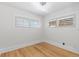 Inviting bedroom with wood floors and two sunny windows at 3225 S Sherman St, Englewood, CO 80113