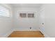 Bright bedroom featuring wood floors, crisp white walls, and a charming window at 3225 S Sherman St, Englewood, CO 80113