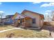 Exterior view of home with covered porch, tiled steps and mature trees at 3225 S Sherman St, Englewood, CO 80113