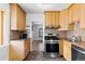 Well-equipped kitchen with stainless steel appliances, wood cabinets, and mosaic backsplash at 3225 S Sherman St, Englewood, CO 80113