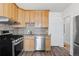 Well-equipped kitchen with stainless steel appliances, wood cabinets, and mosaic backsplash at 3225 S Sherman St, Englewood, CO 80113