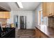 Well-equipped kitchen with stainless steel appliances, wood cabinets, and a glimpse of an adjacent bathroom at 3225 S Sherman St, Englewood, CO 80113