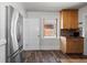 Bright kitchen features stainless steel refrigerator, wood floors, and tile backsplash at 3225 S Sherman St, Englewood, CO 80113