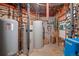Basement with multiple water heaters and plumbing, showcasing the home's utility systems at 9107 S Deer Creek Canyon Rd, Littleton, CO 80127
