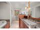 Bright bathroom featuring a spacious vanity, granite countertop, and a view of the outdoors at 9107 S Deer Creek Canyon Rd, Littleton, CO 80127