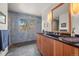Stylish bathroom with tiled walls, a modern vanity, and a large window with scenic views at 9107 S Deer Creek Canyon Rd, Littleton, CO 80127