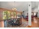 Elegant dining room featuring hardwood floors and an adjacent open-plan living space at 9107 S Deer Creek Canyon Rd, Littleton, CO 80127