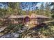 Charming single-story home with a stone chimney and a peaceful, wooded setting at 9107 S Deer Creek Canyon Rd, Littleton, CO 80127