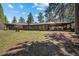 Spacious single-story home with a well-manicured lawn and a covered patio at 9107 S Deer Creek Canyon Rd, Littleton, CO 80127