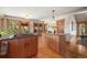 Bright kitchen featuring a center island and access to an outdoor seating area at 9107 S Deer Creek Canyon Rd, Littleton, CO 80127