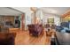 Well-lit living room boasts hardwood floors, a fireplace and ample seating space at 9107 S Deer Creek Canyon Rd, Littleton, CO 80127