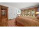 Comfortable main bedroom with hardwood floors and access to an outdoor seating area at 9107 S Deer Creek Canyon Rd, Littleton, CO 80127
