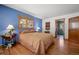 Inviting main bedroom with hardwood floors, a window, and an ensuite bathroom at 9107 S Deer Creek Canyon Rd, Littleton, CO 80127
